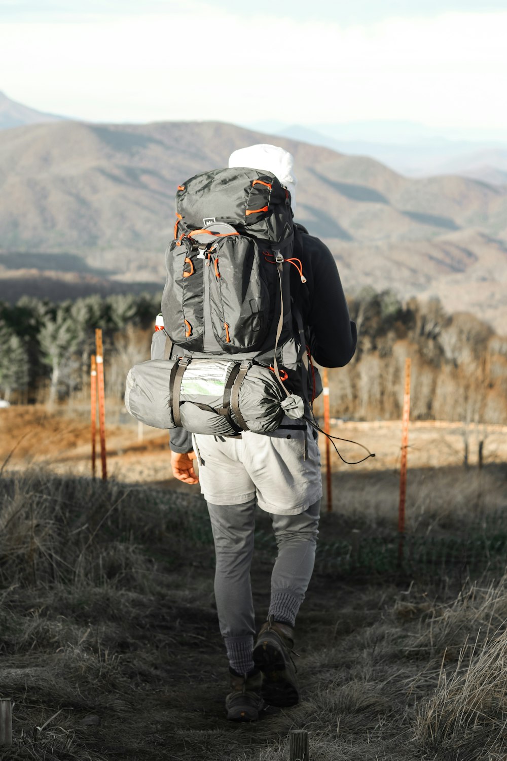 man walking near mountain hill during daytime