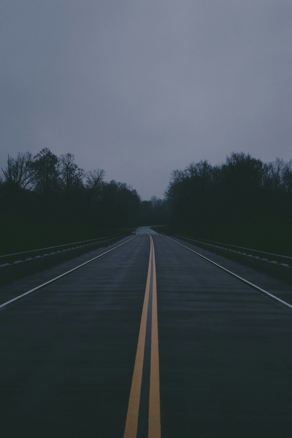 empty gray concrete road during nighttime