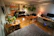 A modern studio apartment showcasing a stylish sofacum bed in use as a bed at night.