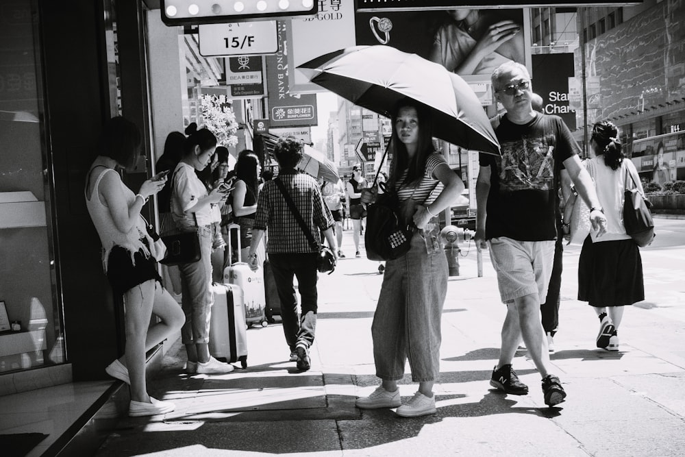 grayscale photo of people in street