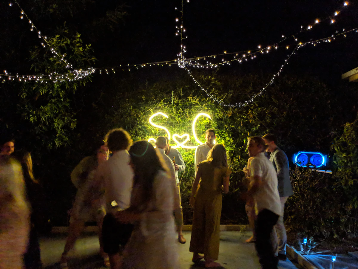 Guests gathered close together at a night-time reception