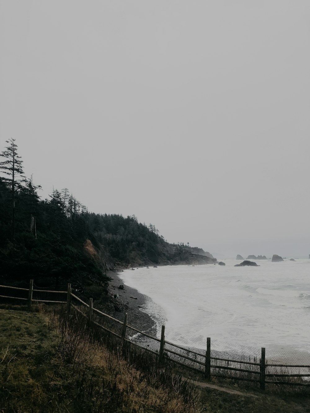 sea near the mountain during daytime