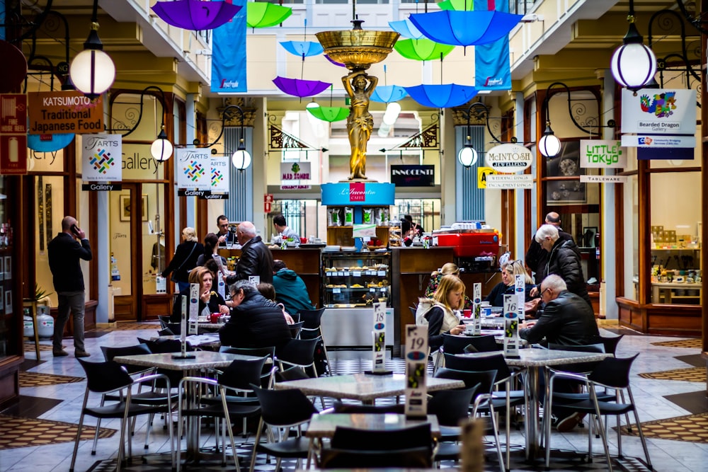 people sitting and standing inside restaurant