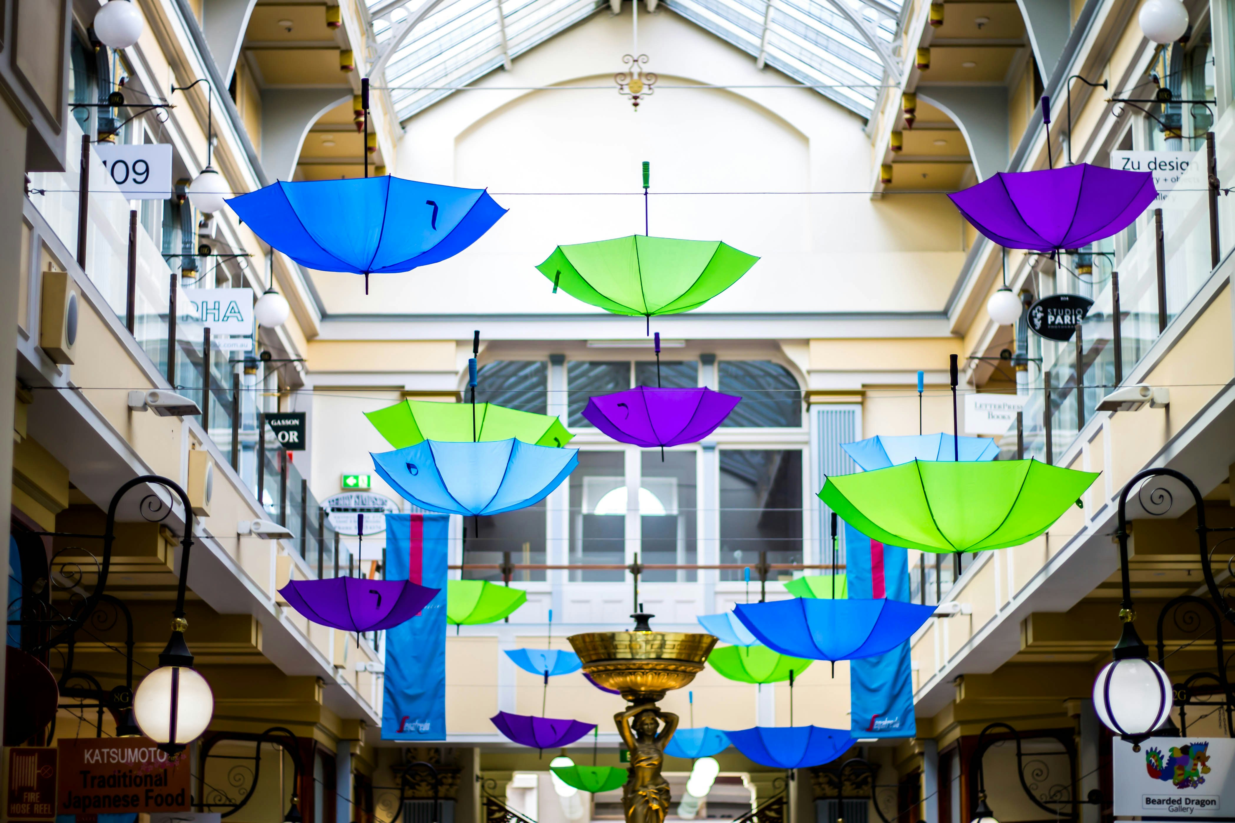 assorted-color umbrella hanging decors in buildding