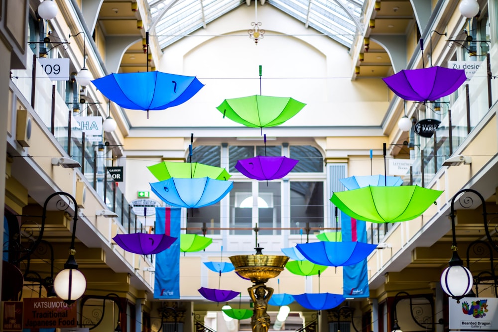 assorted-color umbrella hanging decors in buildding
