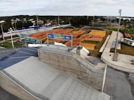 A group of smiling kids gathered around the BMX track, ready to race.