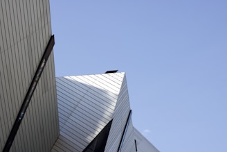 A clean architectural shot emphasizing sharp lines and geometric shapes against a bright sky.