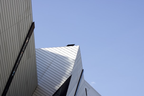 A clean architectural shot emphasizing sharp lines and geometric shapes against a bright sky.