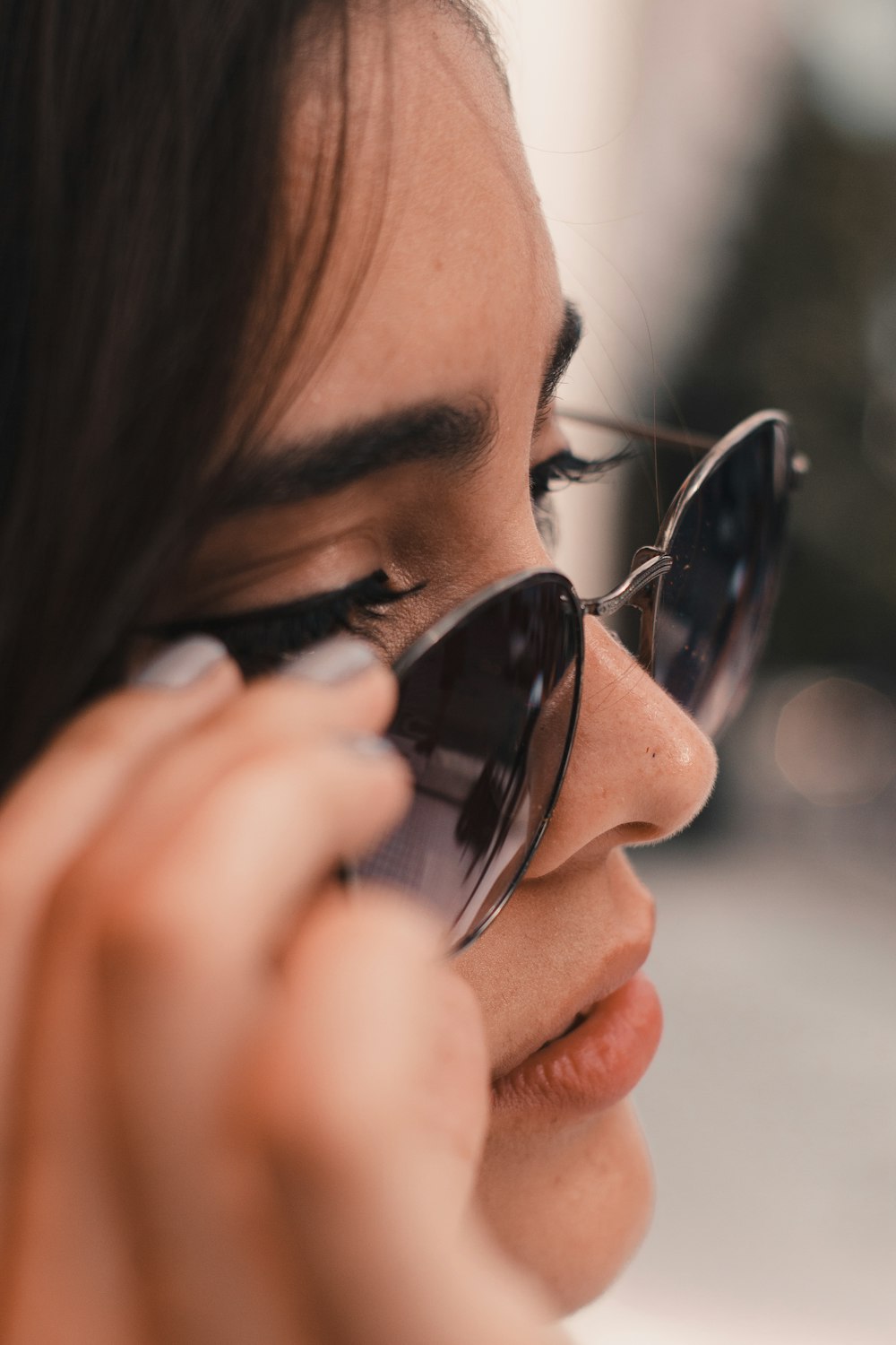 woman wearing gray framed sunglasses