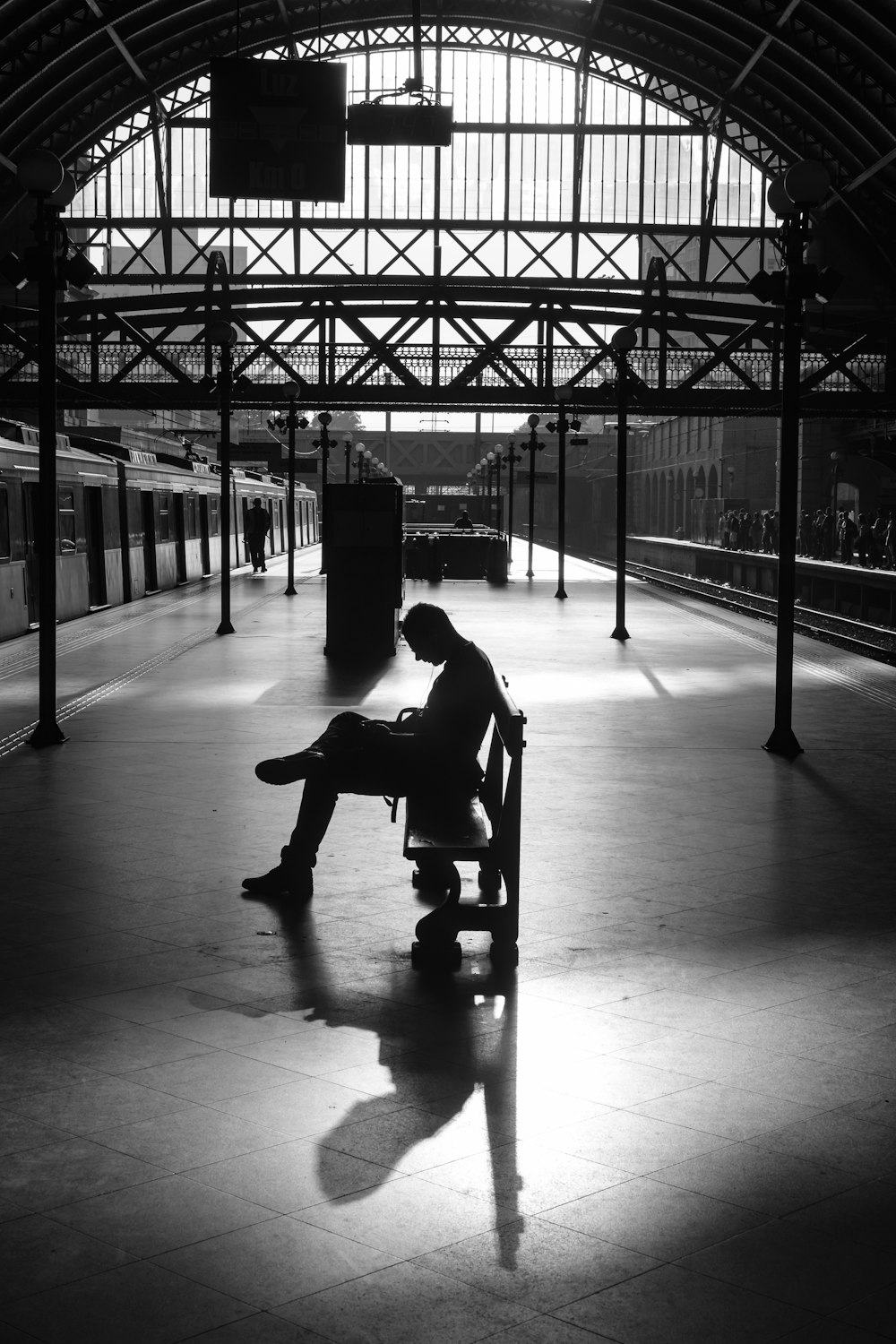 silhouette photography of person sitting on bench