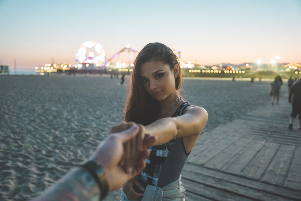 man holding woman's hand while standing