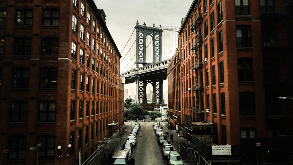 cars parked on both sides of street near bridge