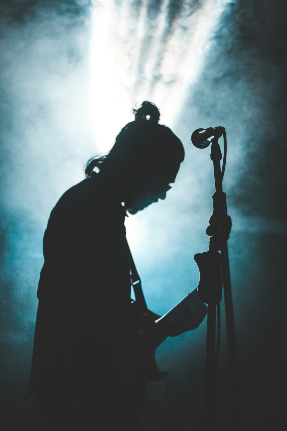 silhouette photography of person playing guitar