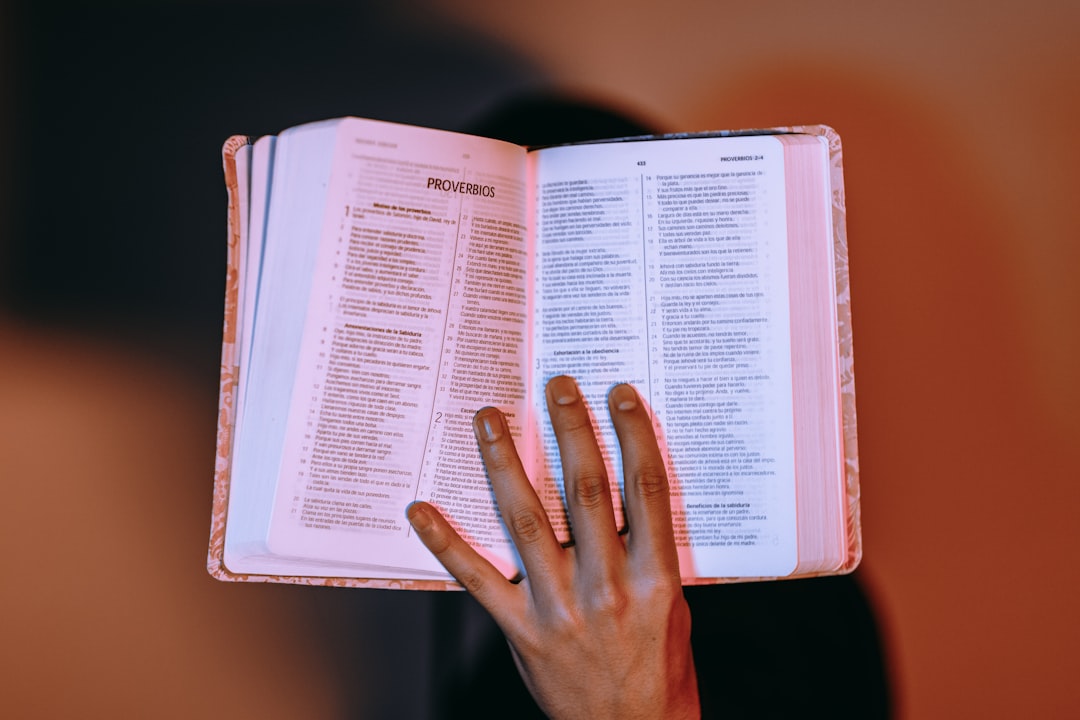 person touching open bible