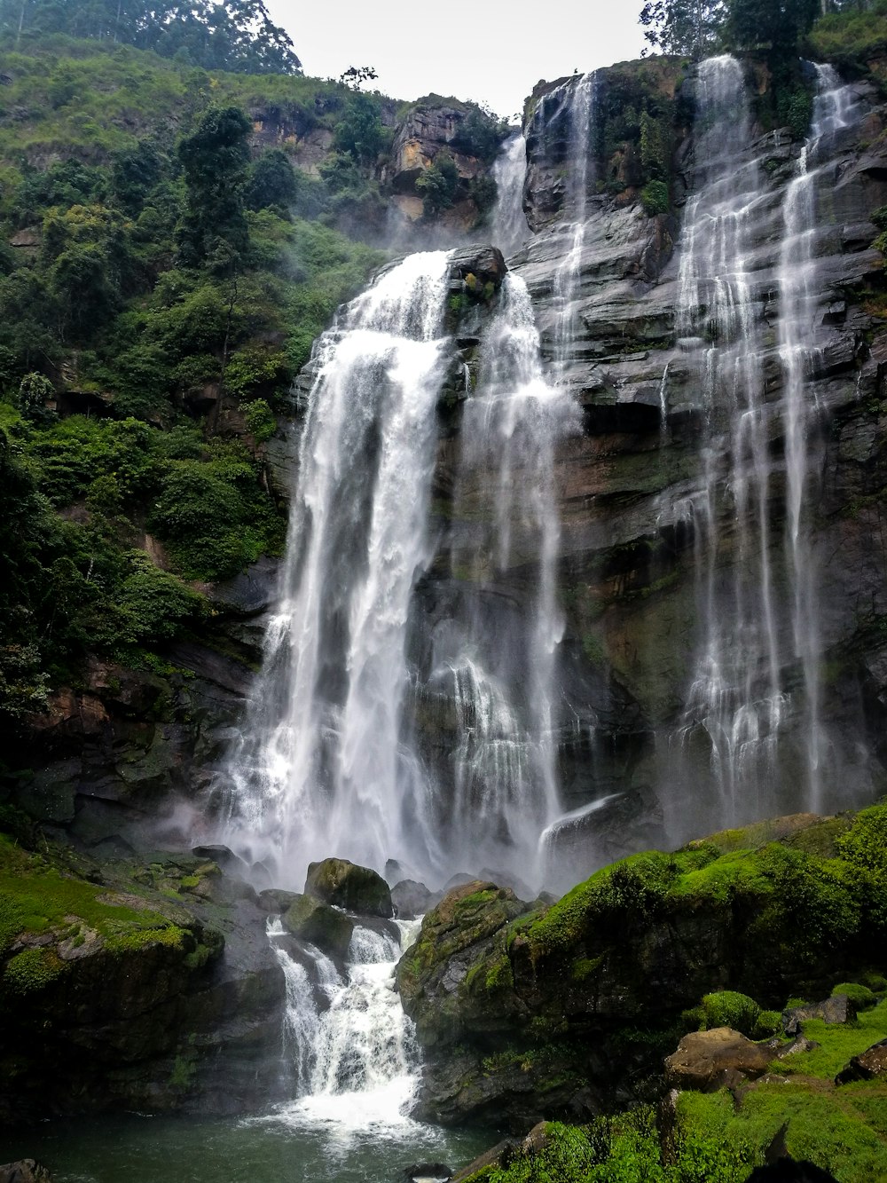 cascading waterfalls on rock wall