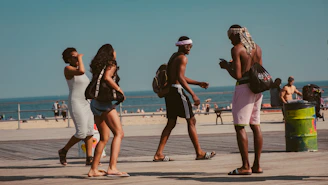 people walking onpathway near seashore
