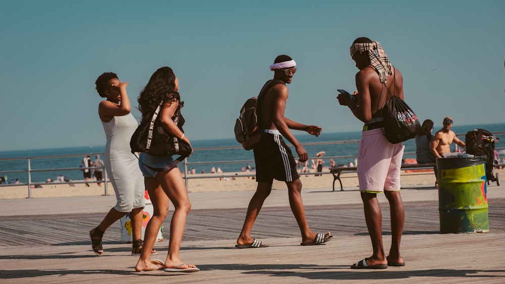 people walking onpathway near seashore