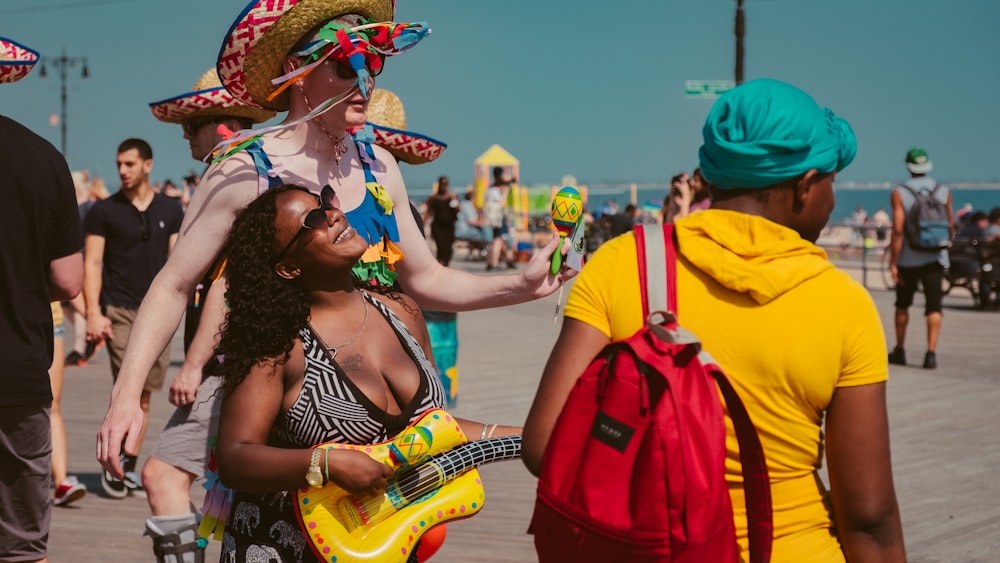 woman playing yellow guitar outdoor near the beach