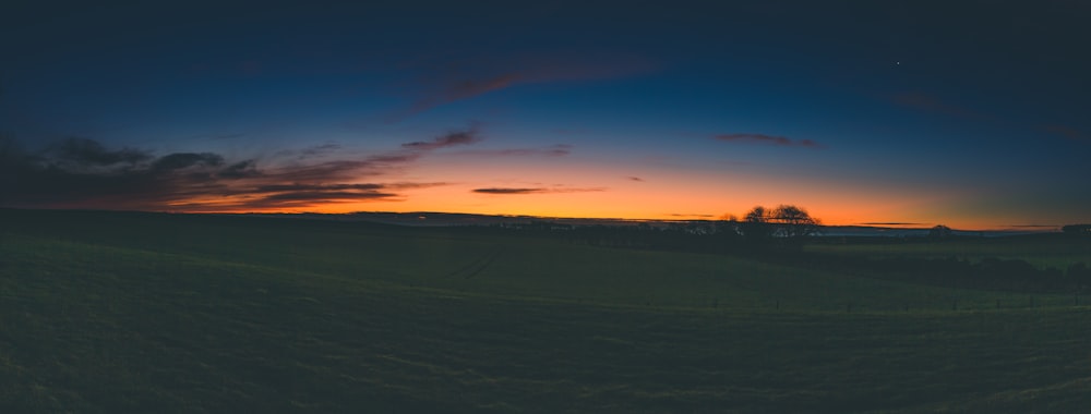 orange setting sun across ffiels