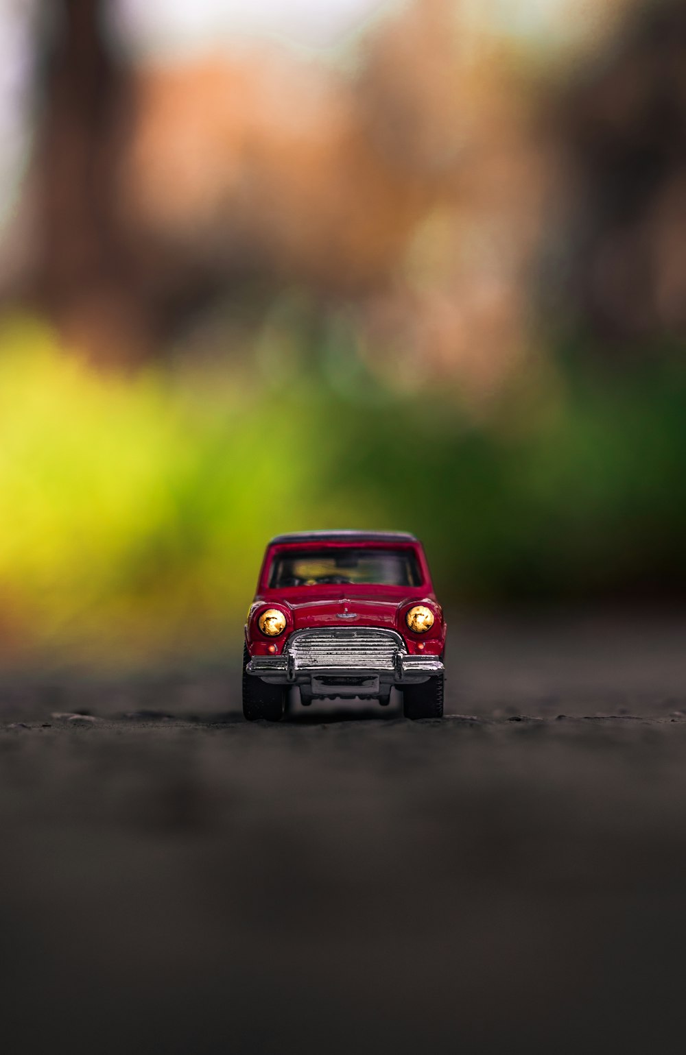 red car die-cast model on gray surface