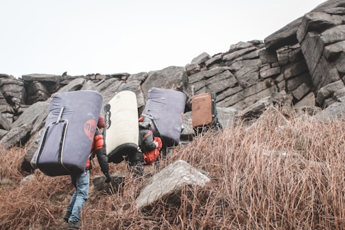 A group of diverse people practicing bouldering together.