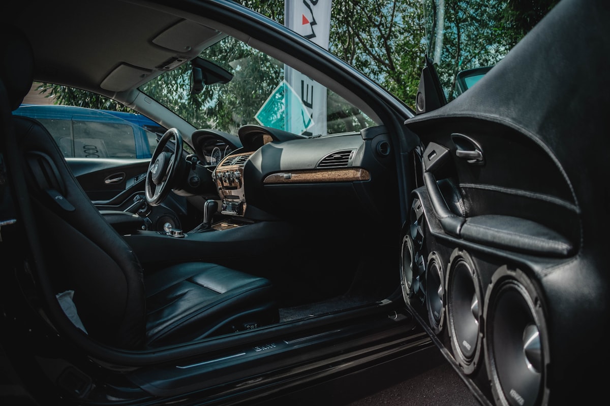 Custom car audio subwoofer installation showing amplifier and speaker wiring in a vehicle boot