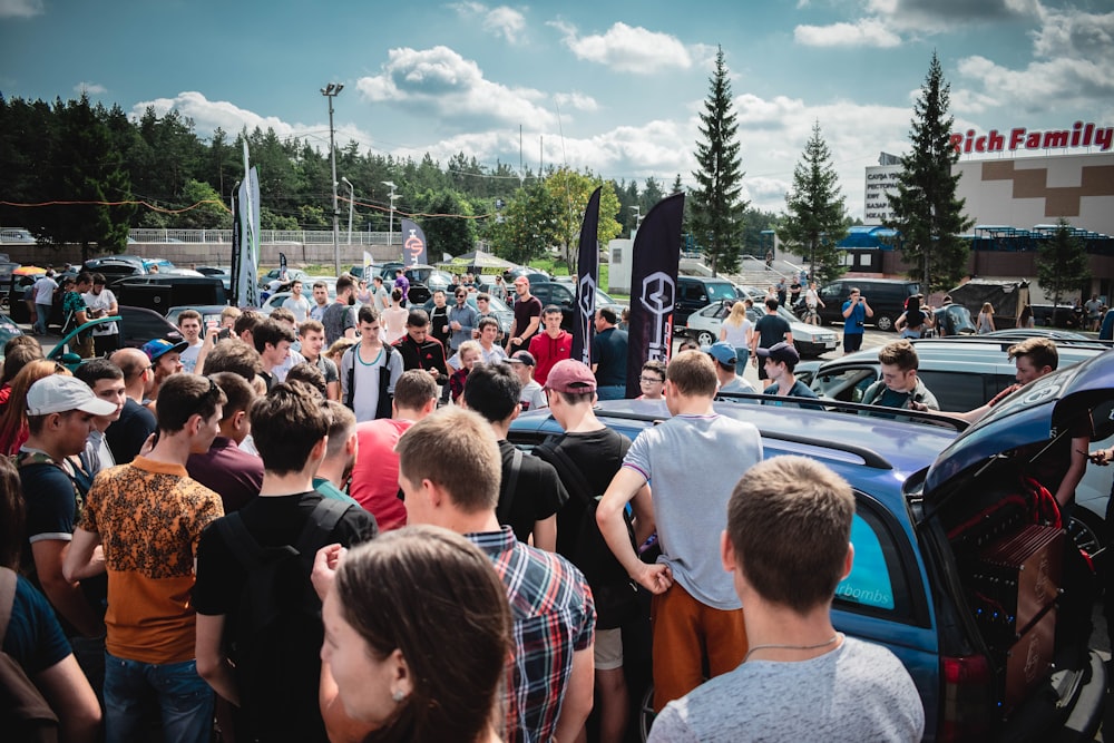 people gathering beside car