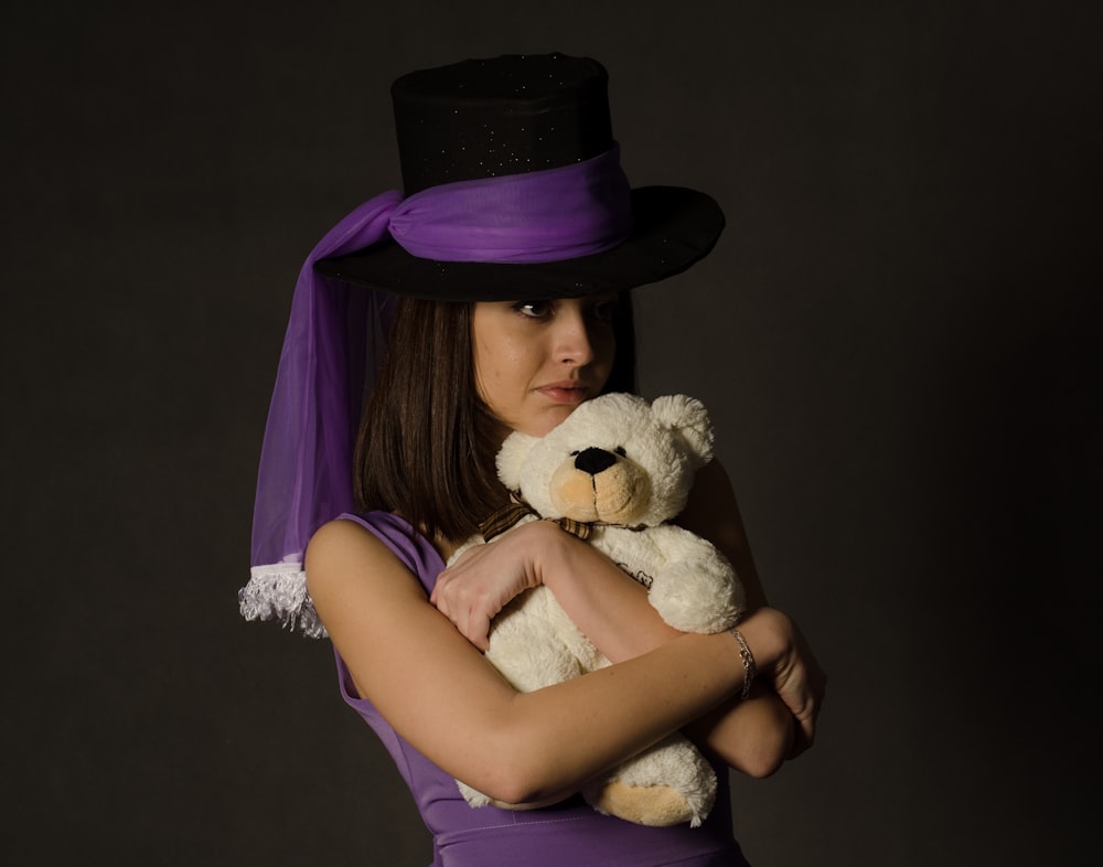woman holding white teddy bear