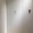 A plain light-colored wall features a door labeled with the number 8 and the word 'CRAFT' in bold black letters. To the right, a bulletin or flyer is affixed to the wall with a small colorful image and text.