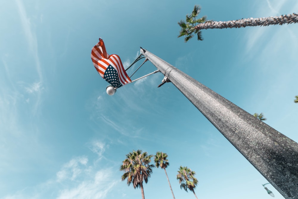american flag flying on pole low angle photo