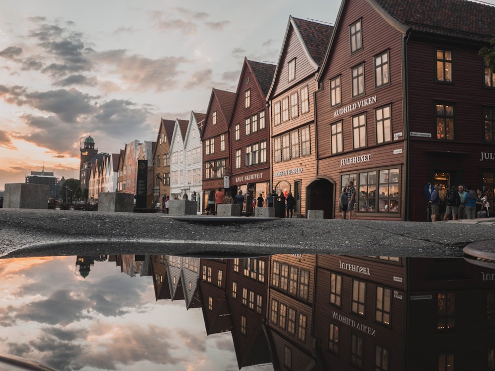 photo of houses with reflection on body of water