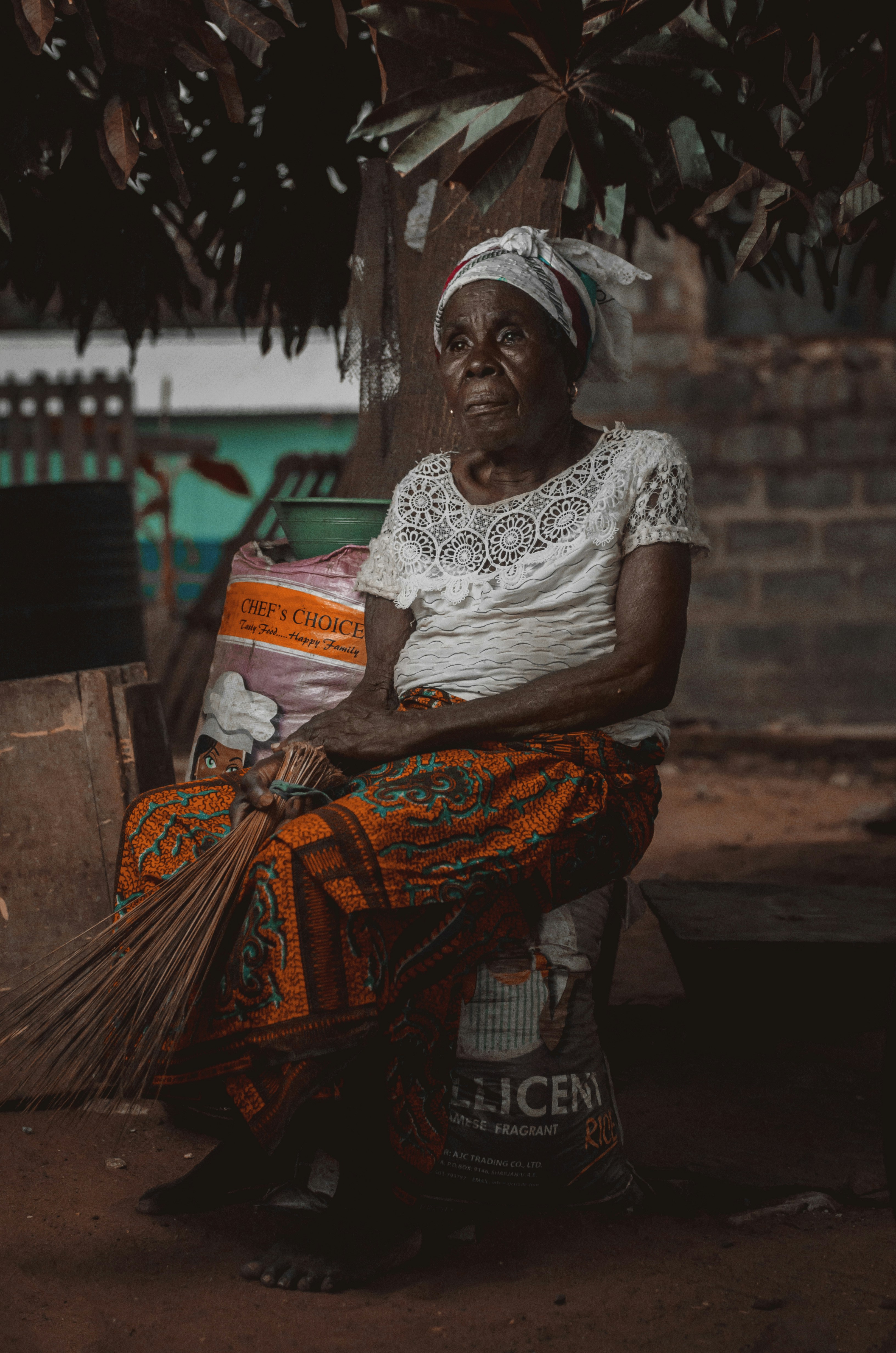 sitting woman holding to stick broom during daytime