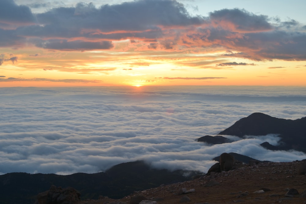 white clouds formation under orange skies