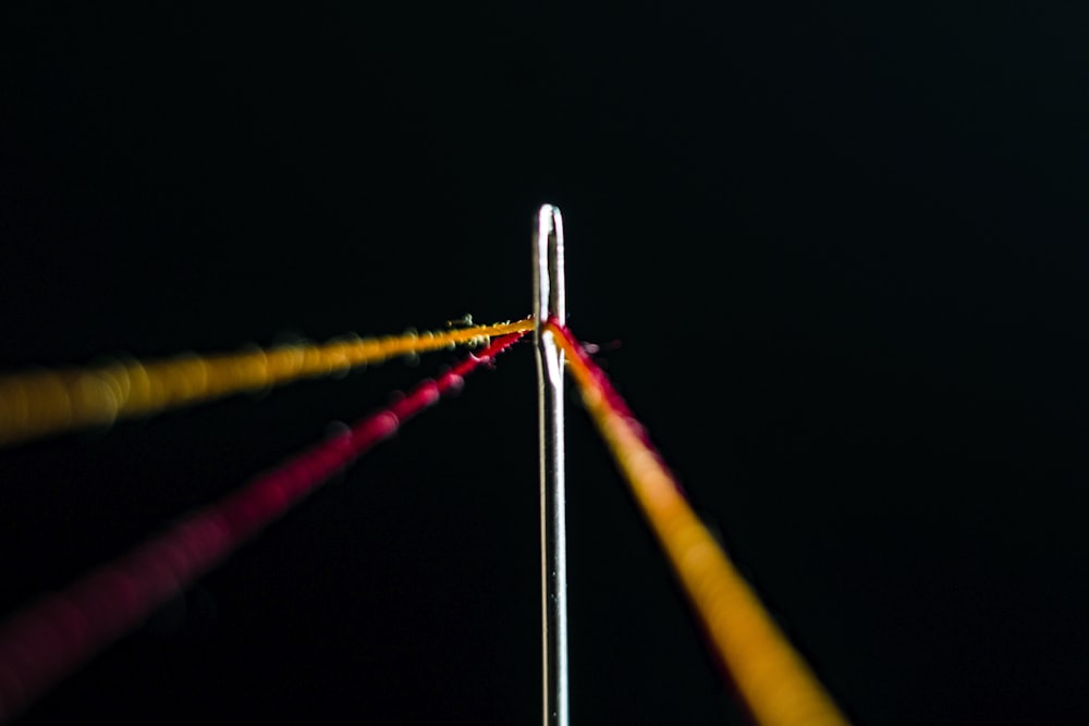 red and yellow thread in needle