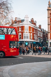 A vibrant street scene in Shoreditch on a sunny day, with subtle brick reds and underground blues reflecting the London color palette.