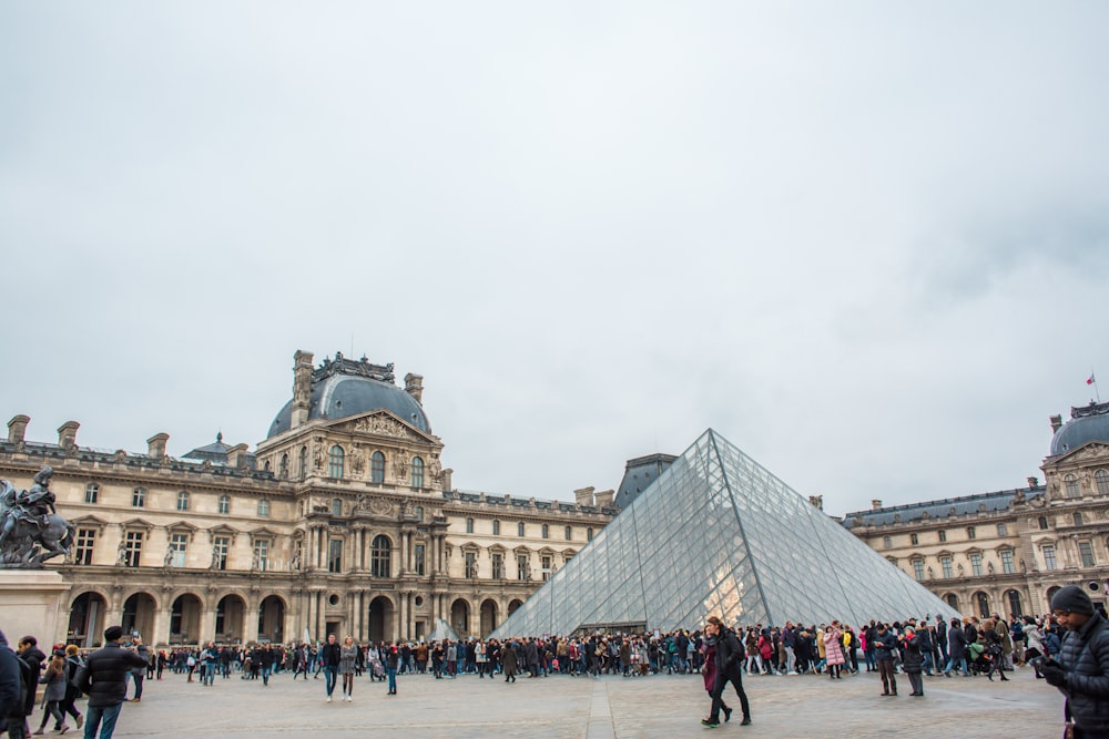 people standing near Louvre Museum