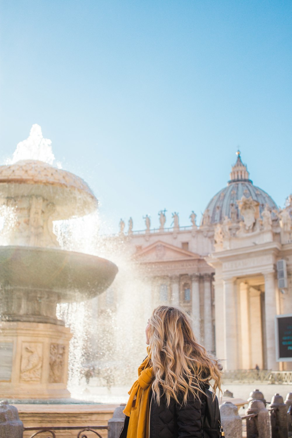 girl watching fountain outdoor during daytime