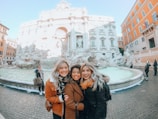 A group of travelers enjoying a personalized tour with a driver near the Trevi Fountain.
