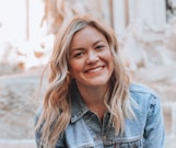 woman smiling wearing denim jacket