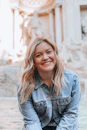 woman smiling wearing denim jacket