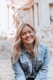 woman smiling wearing denim jacket