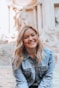 woman smiling wearing denim jacket
