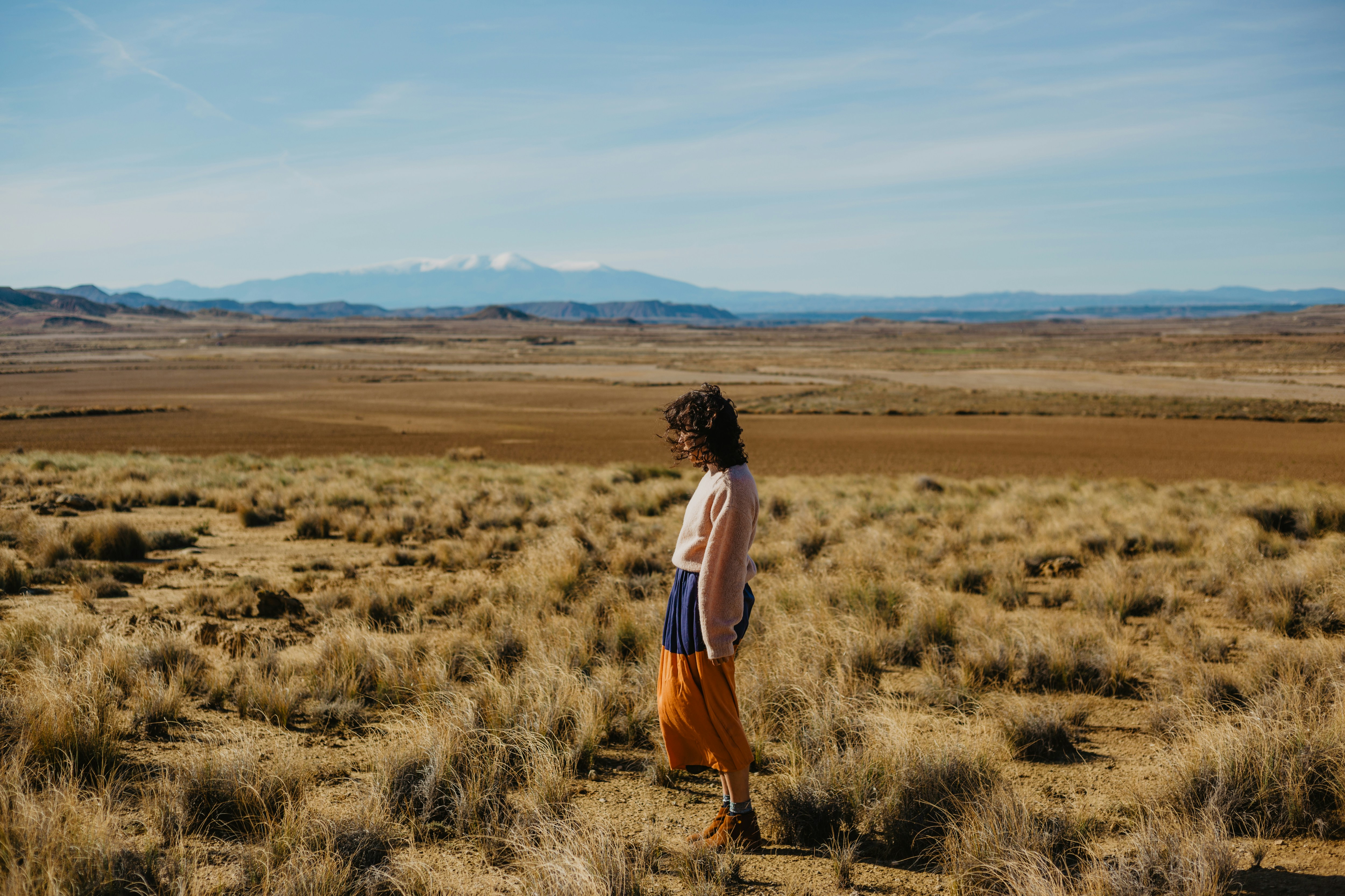 woman standing on brown grasses