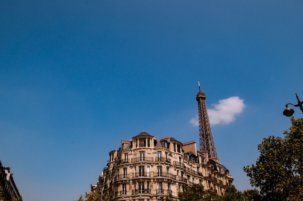 building beside tower under blue sky