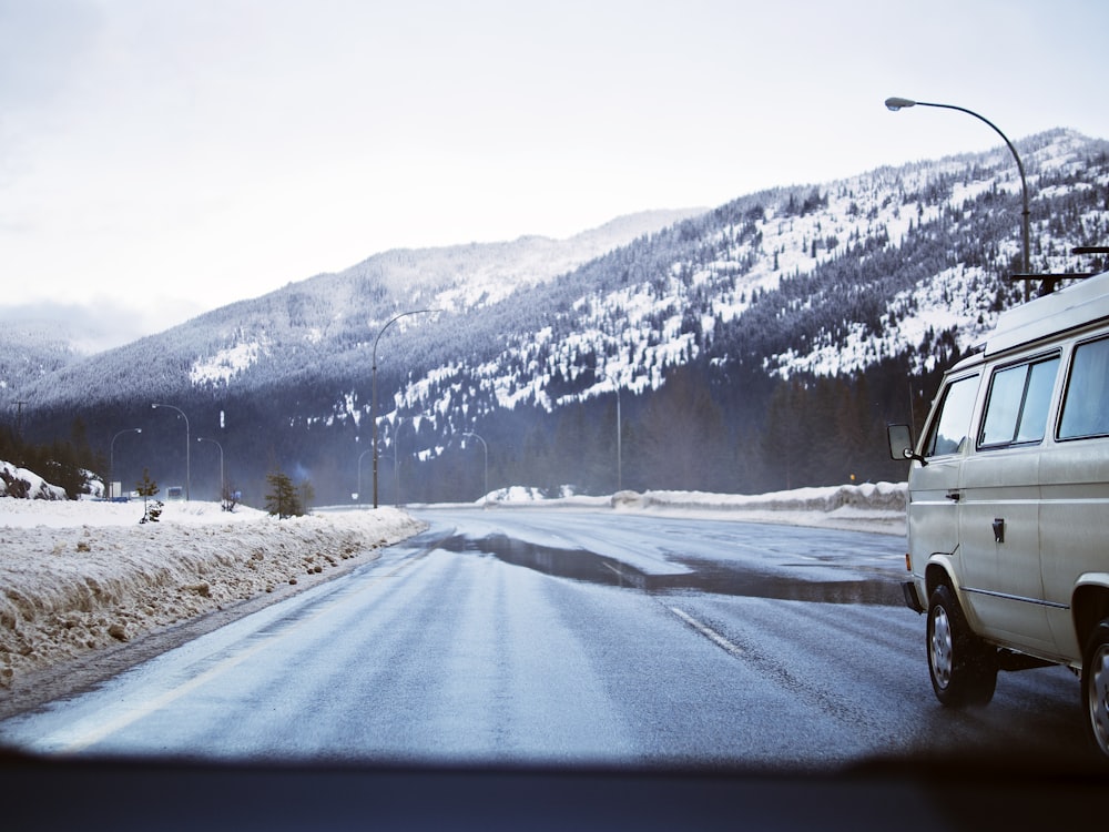 white van crossing road during daytime