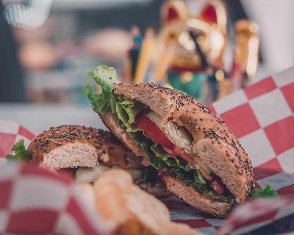 selective focus photography of burger with tomato and lettuce