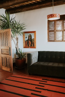 A cozy living room featuring a plush hand-tufted rug with bold geometric designs in rich reds and blues.
