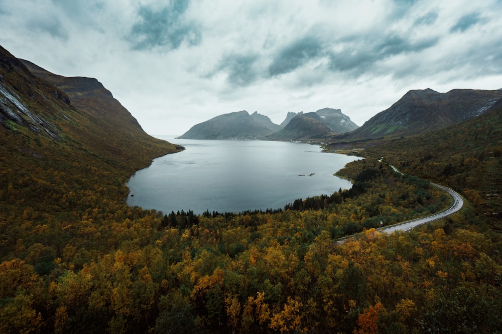 calm body of water between mountain