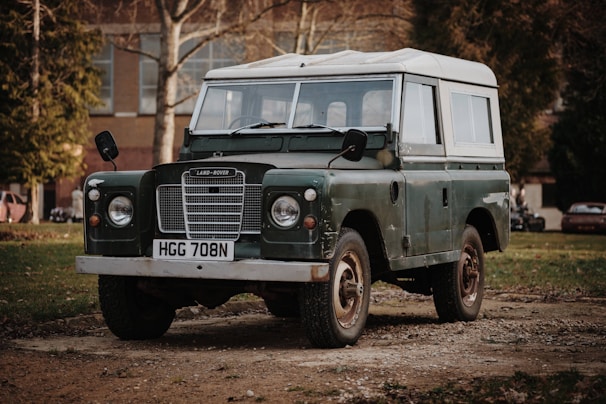 green and white Land Rover SUV on road