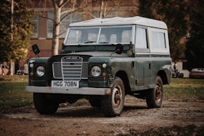 green and white Land Rover SUV on road